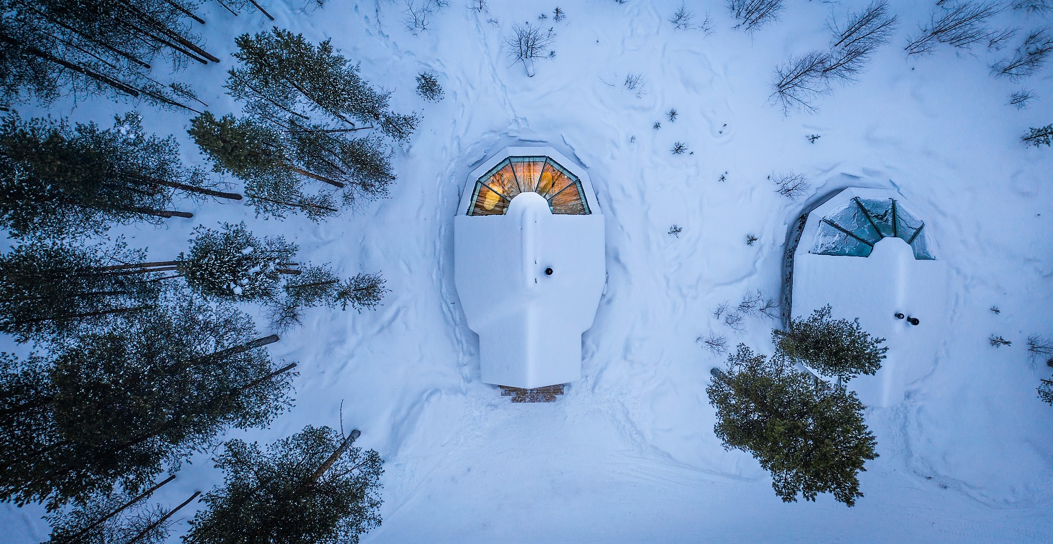 Aerial view of an aurora cabin in the snowy wilderness at Aurora Village in Finnish Lapland