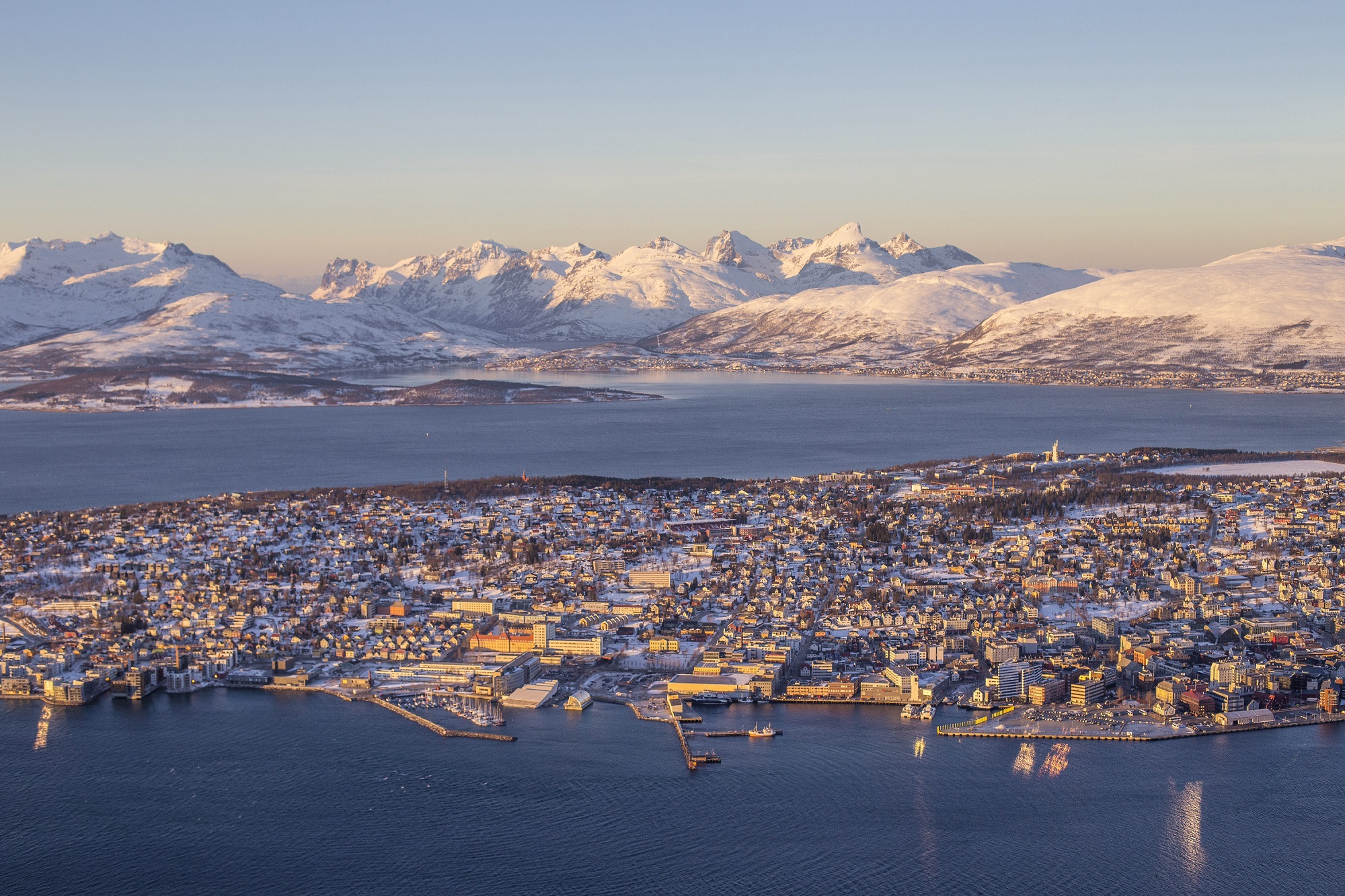 Birds-eye view of the beautiful cityscape with the dramatic mountain range behind in Tromsø in Norway.