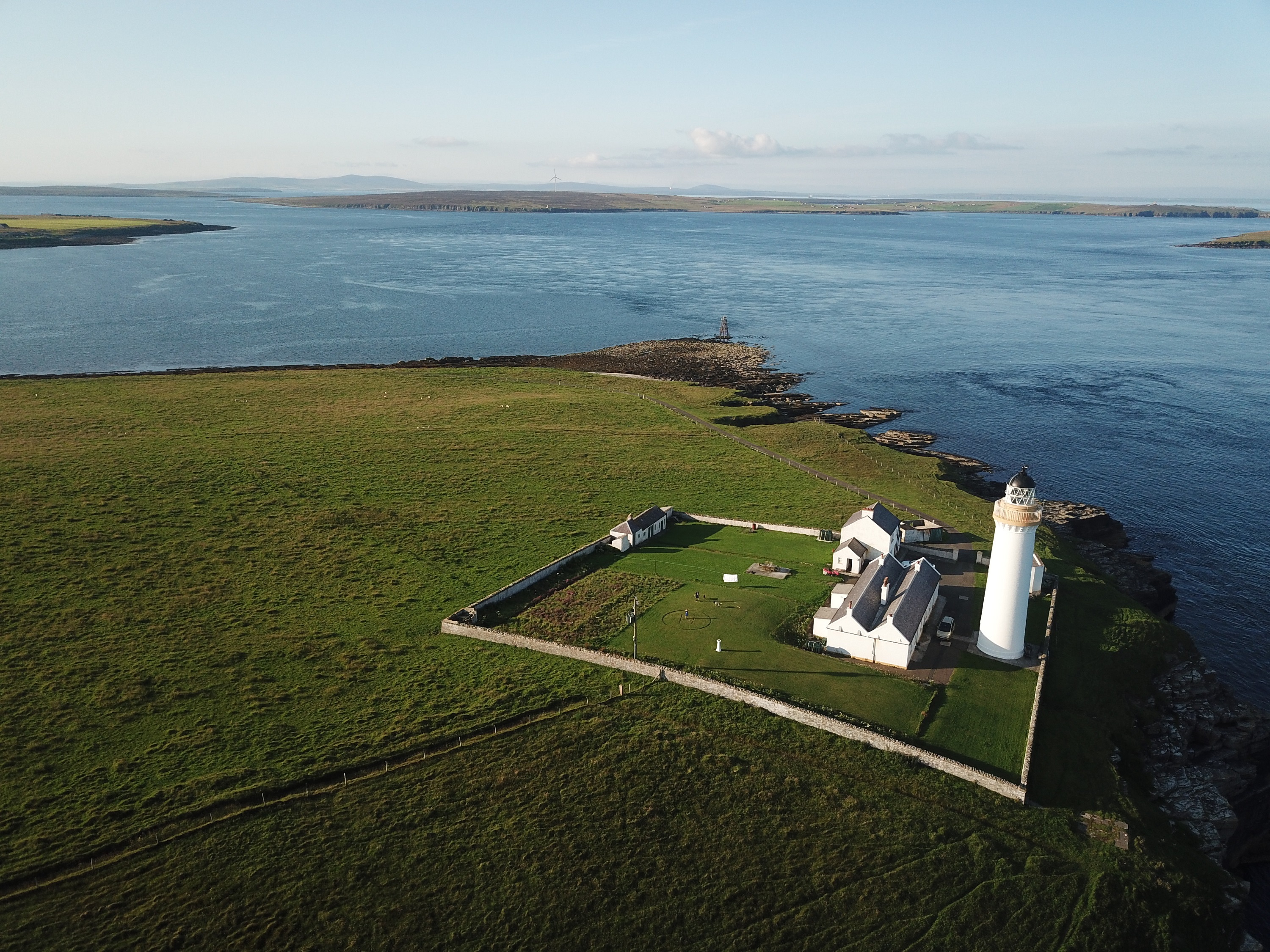 Ariel view over Cantick Head Lighthouse and the sea beyond on Orkney in Scotland